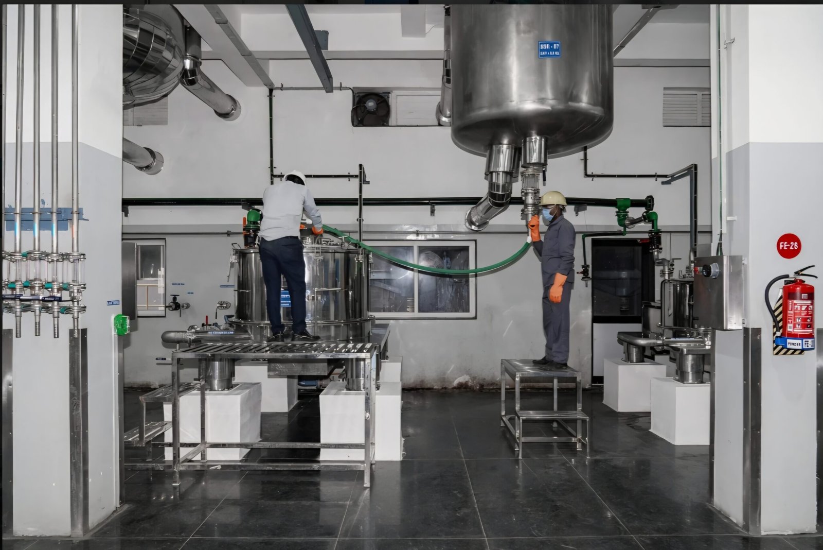 Workers charging a reactor on the production floor